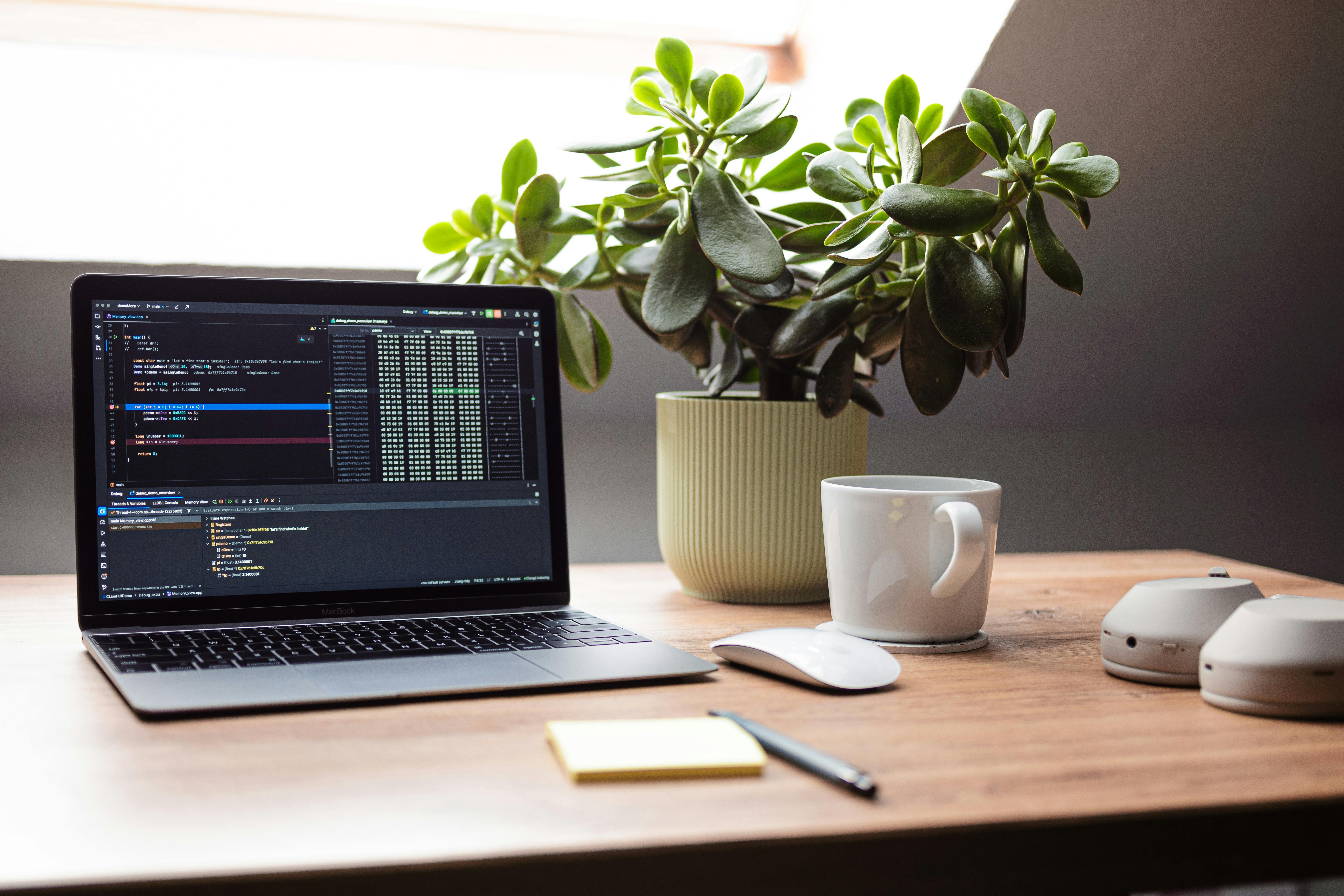 A modern home office with natural light and a large desk setup.